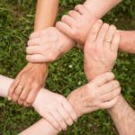 Group of People Holding Arms
